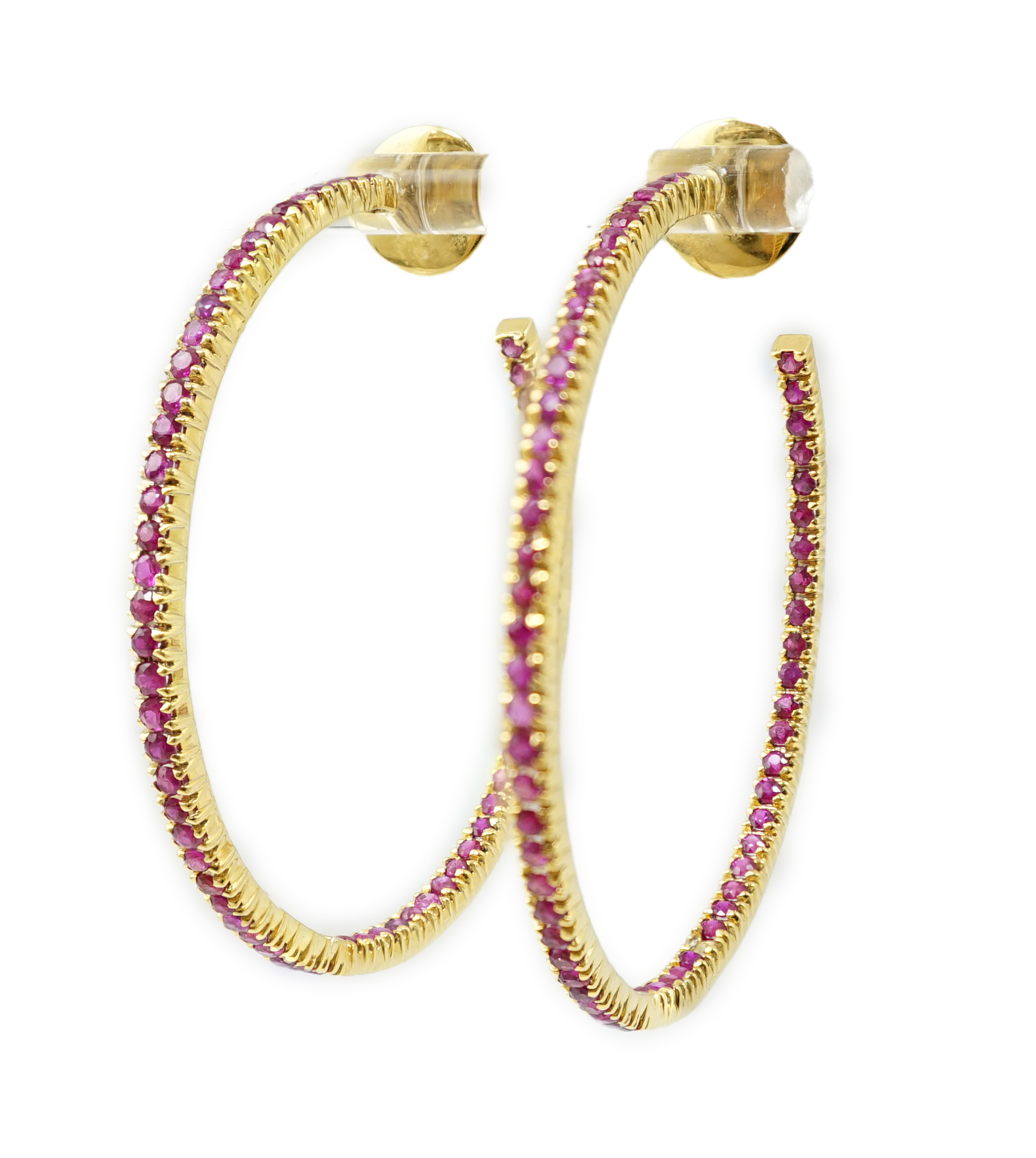 A large pair of gold and ruby chip set hoop earrings